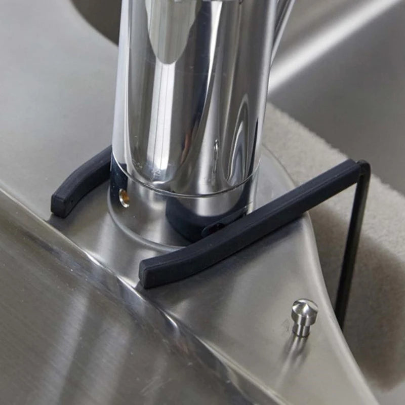 Closeup of black holder's silicone grip arms resting on faucet base