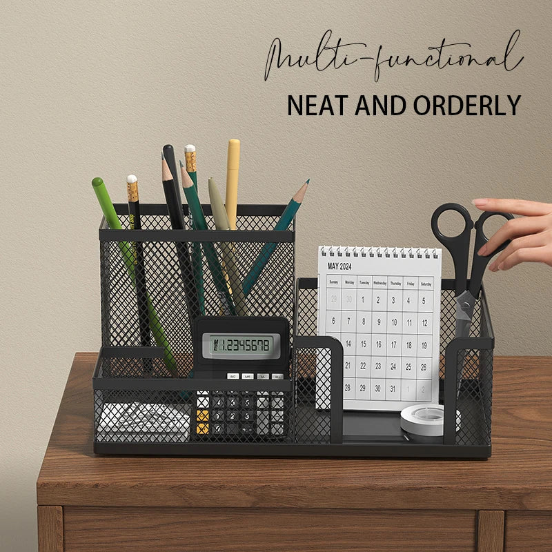 black mesh desk organizer neatly holding pens, a calendar, and scissors on a wood desk