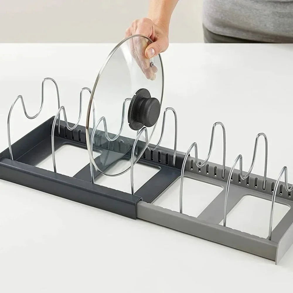 Person placing a glass lid into the adjustable metal organizer rack