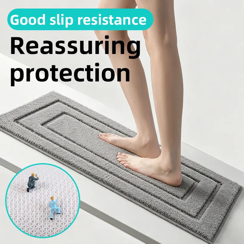 Person's bare feet on a rectangular gray anti-slip mat, showing texture and slip-resistant backing