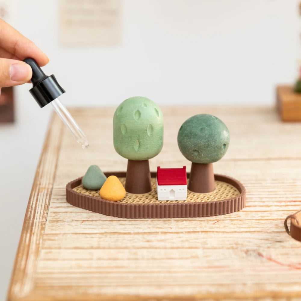 Mini grove stone essential oil diffuser with house and trees on tabletop