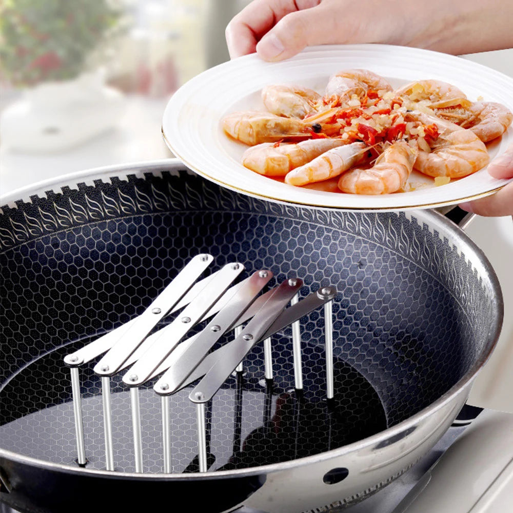 Retractable metal organizer rack being used as a steaming rack inside a frying pan
