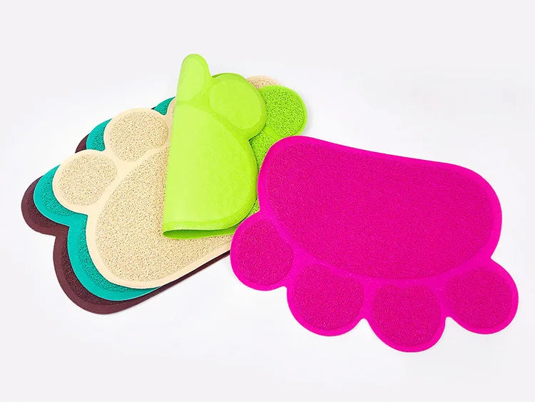 Stack of colorful paw print cat litter mats in various colors