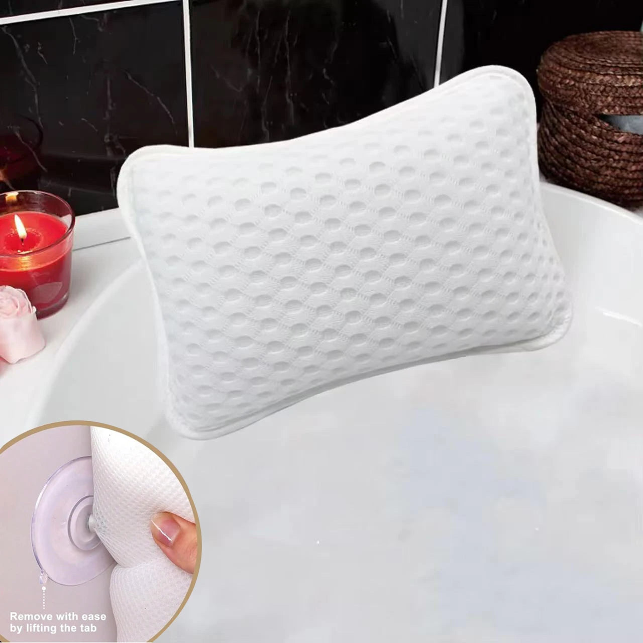 White textured bathtub pillow with suction cups pressed to the edge of a bathtub, candle nearby