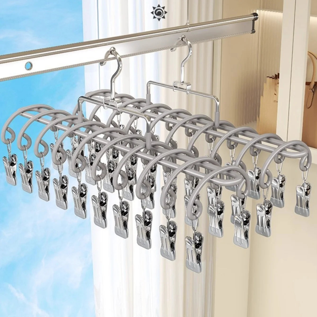 gray stainless steel 20-clip hanging drying rack suspended on an indoor closet rod