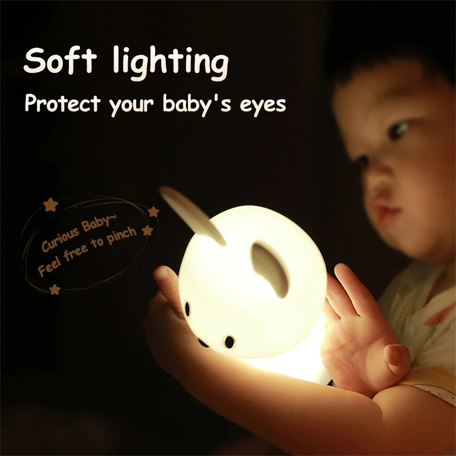 child holding soft silicone bunny night light in hands
