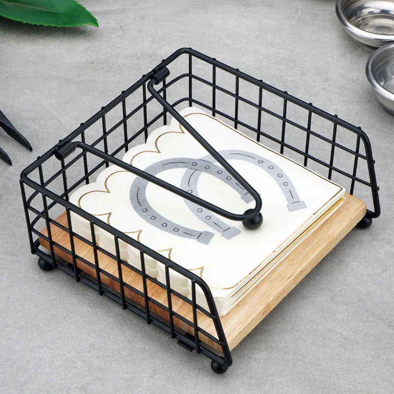 Rustic black metal and wood napkin holder with napkins on a kitchen counter