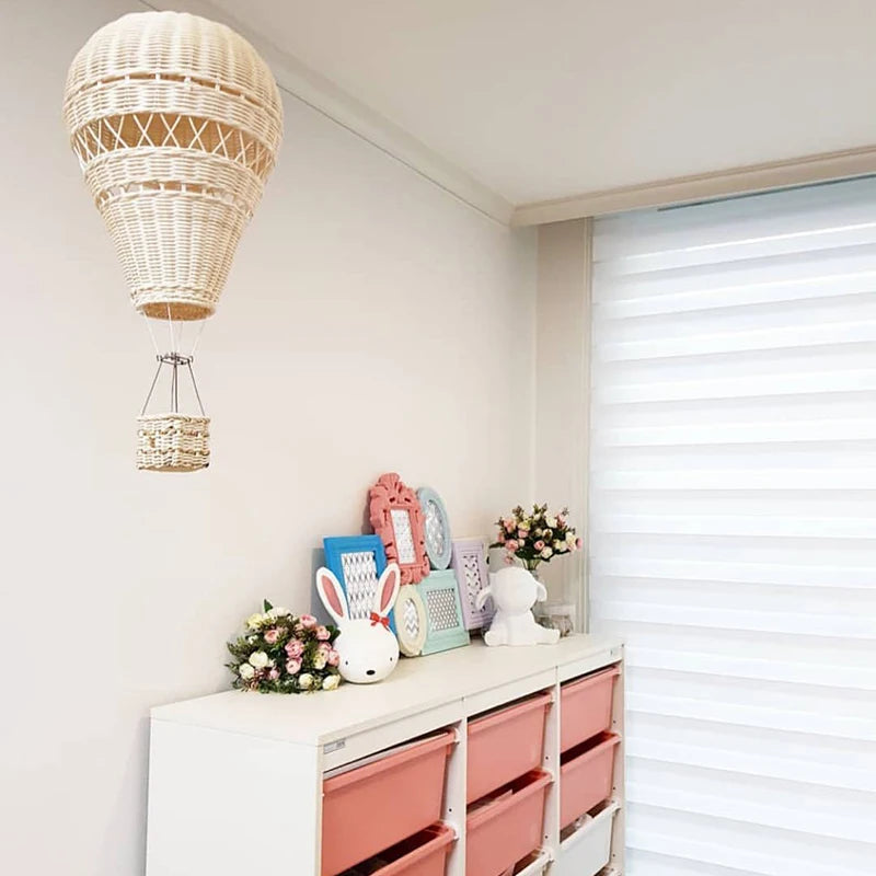 rattan hot air balloon wall decor in kids room above storage unit