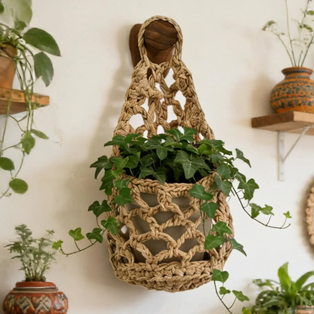 Brown cotton rope macrame hanging plant basket on wall with green ivy