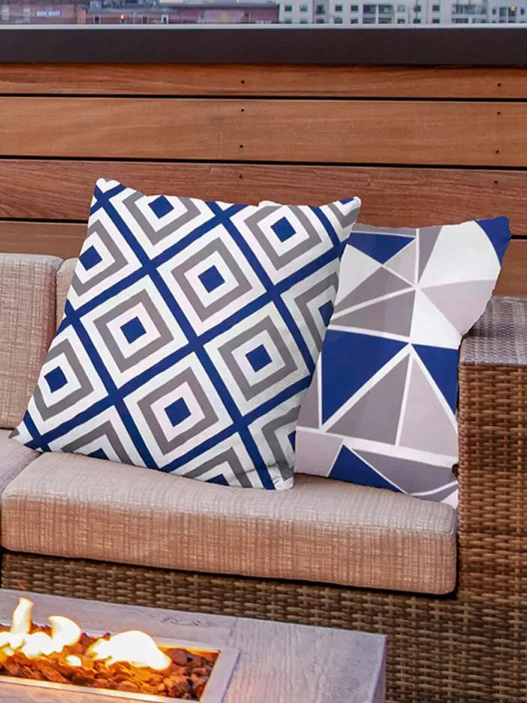 Blue and gray geometric square cushion covers in modern prints on patio seating