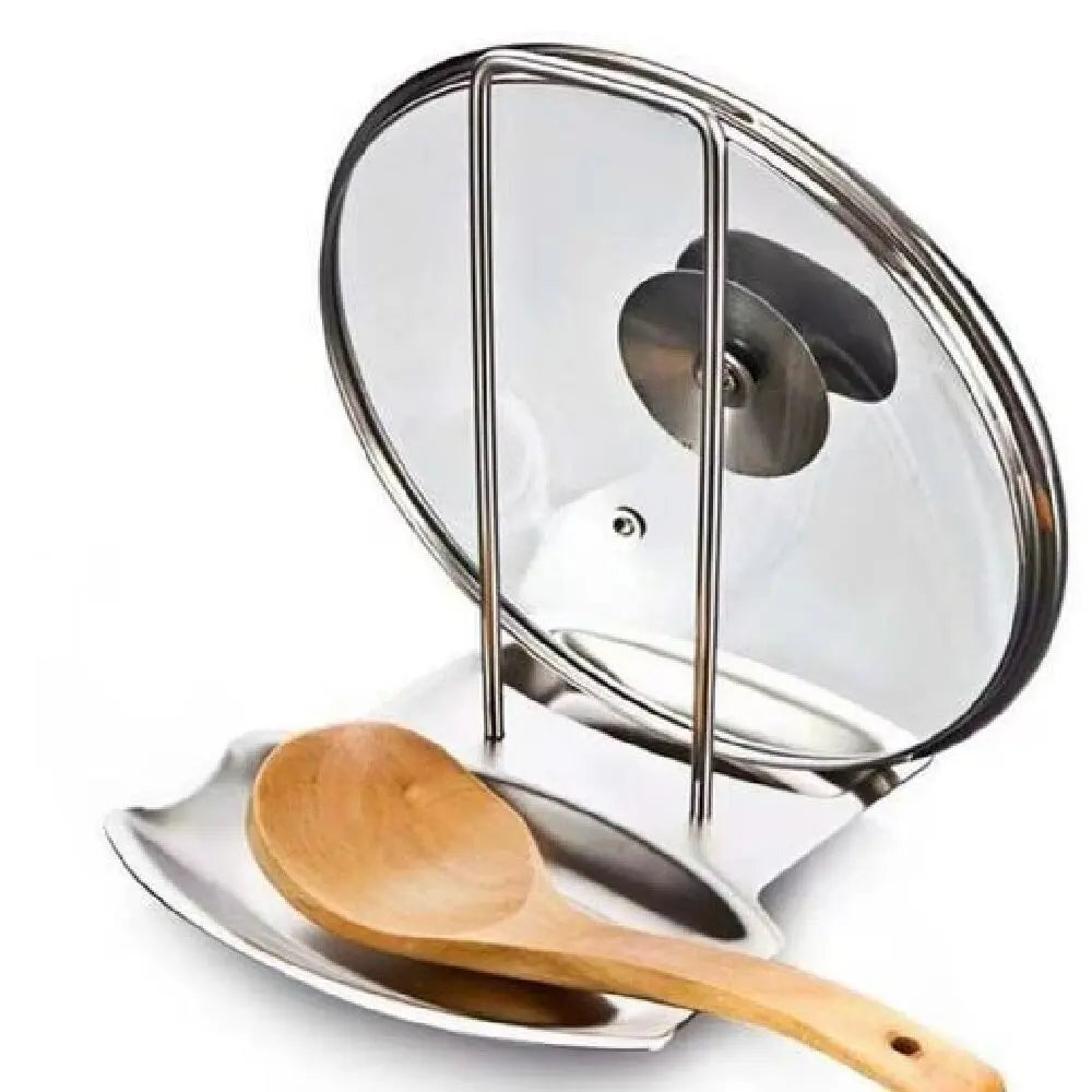 Angled view of stainless steel pot lid and utensil holder holding a glass lid and wooden spoon