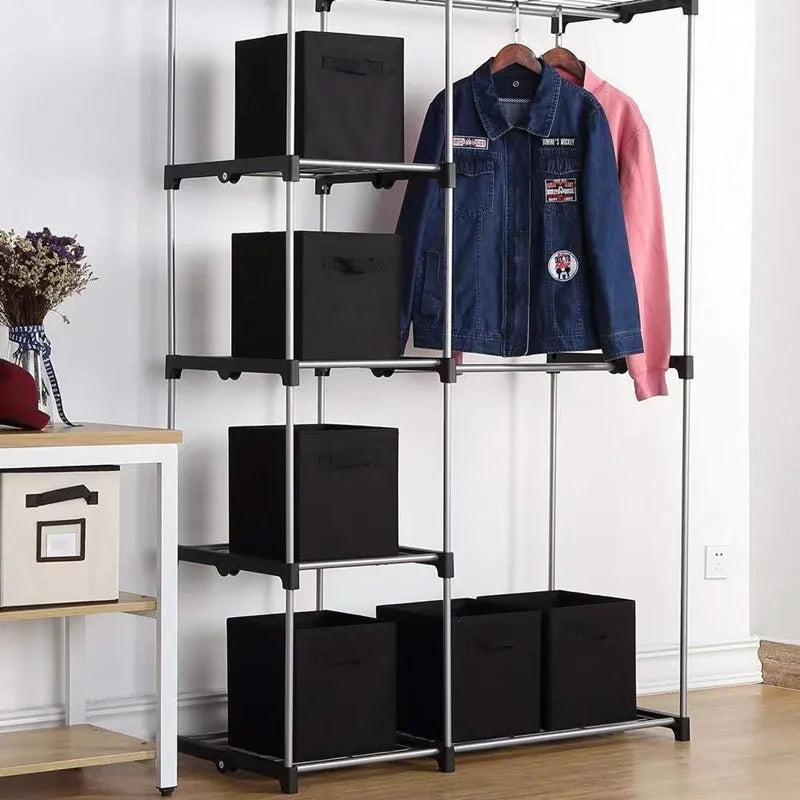Black fabric cube bins arranged in a closet shelving unit with hanging jackets above