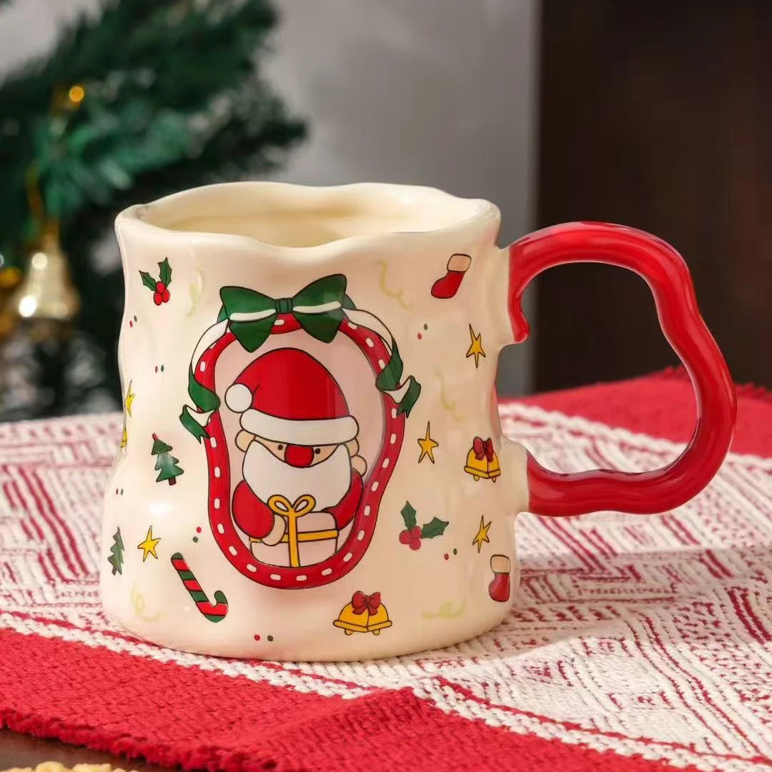 Santa-themed ceramic Christmas mug with festive design and red handle on a holiday tablecloth