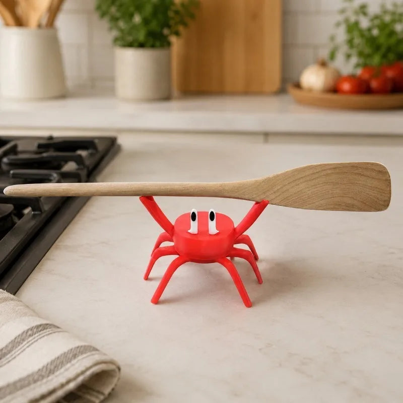 Cute red crab spoon rest with a spatula on a kitchen counter