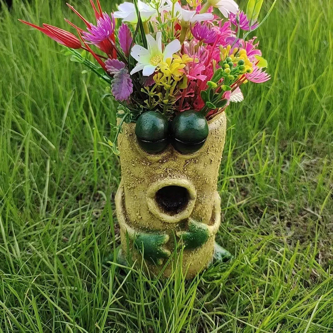 Tall retro-textured frog resin planter with flowers in green grass