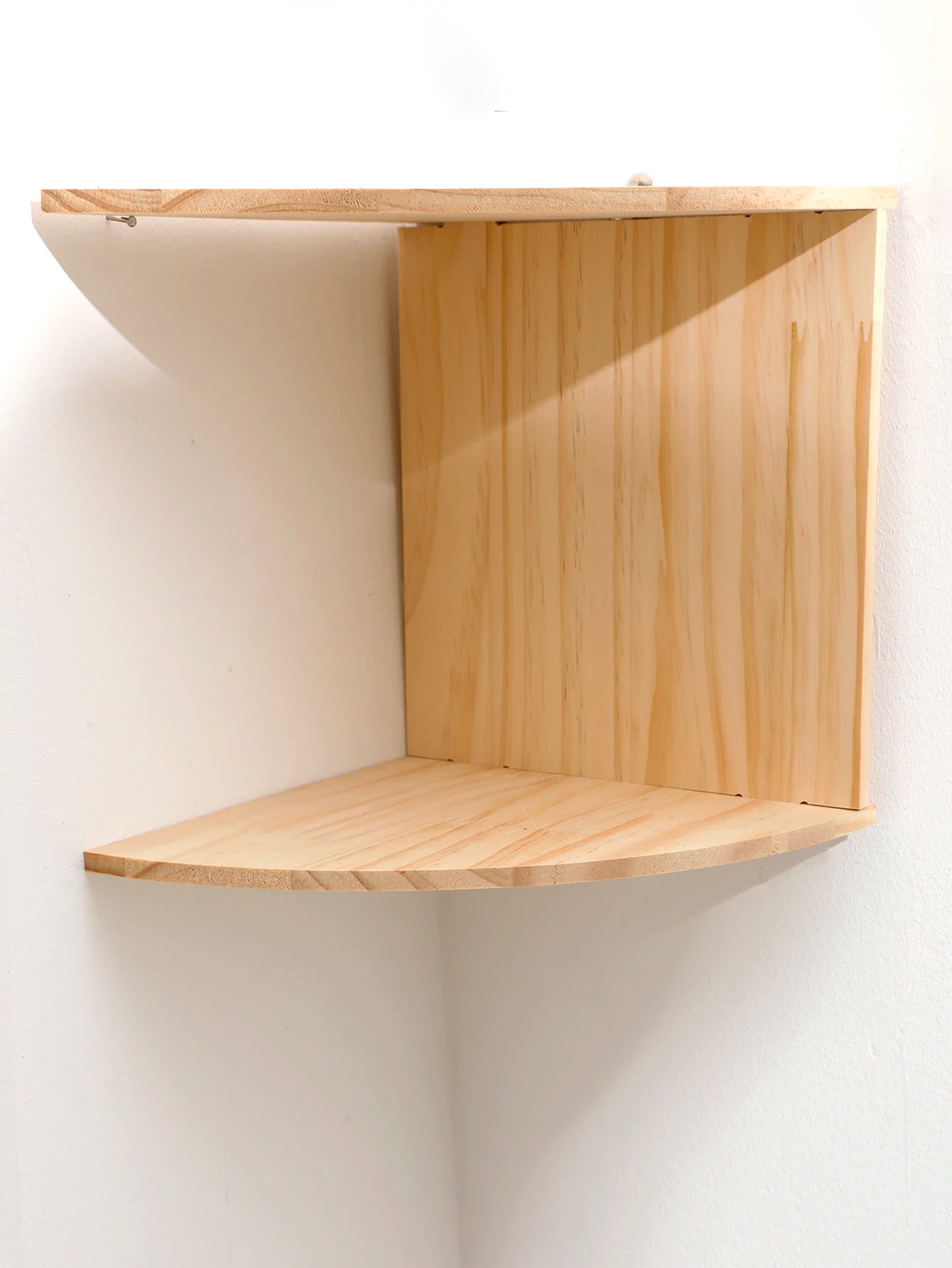 angled view showing natural wood finish of empty two-level corner shelf