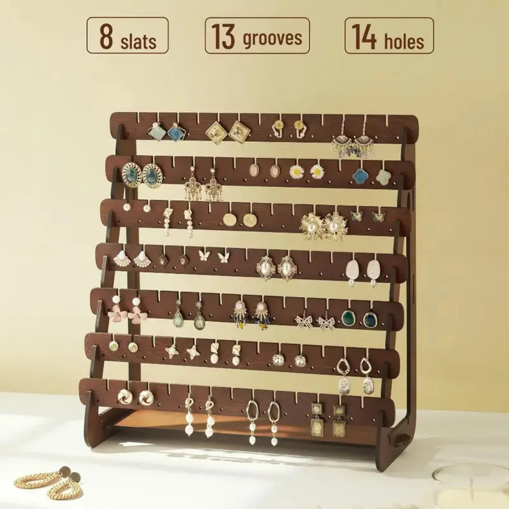close-up of the earring organizer showing eight slats with grooves and holes, filled with various earring styles