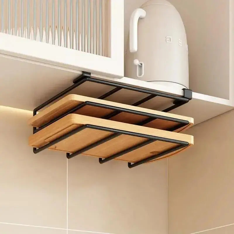 Black hanging rack under a kitchen cabinet with two cutting boards stored underneath