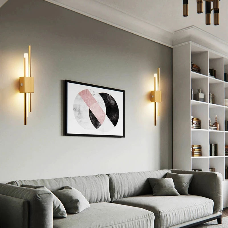 Pair of gold LED wall sconces above sofa in modern living room
