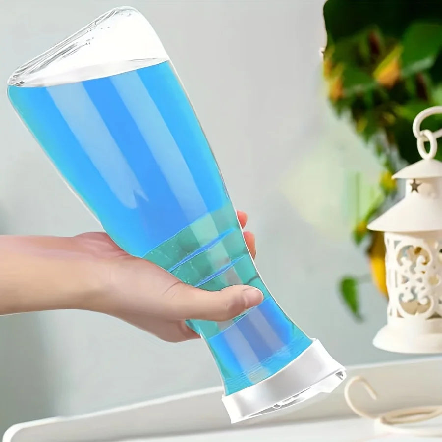 Close-up of a single hand holding a clear plastic laundry bottle filled with blue liquid outdoors