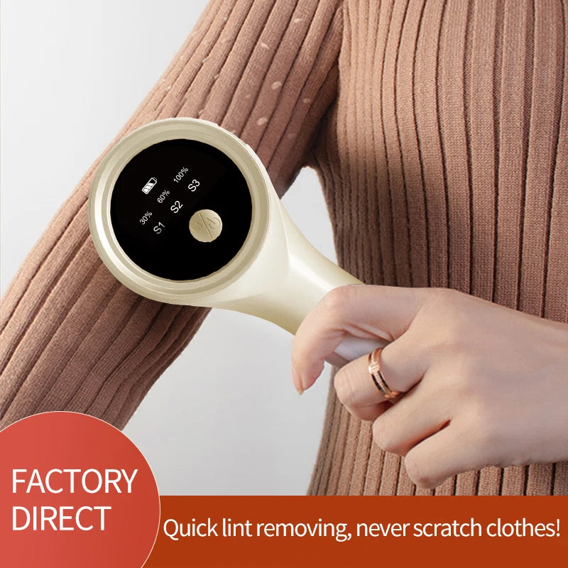 Light yellow electric lint remover being used on a ribbed sweater sleeve
