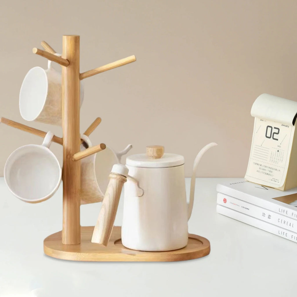 Bamboo mug tree holder on kitchen counter with mugs, kettle, and calendar