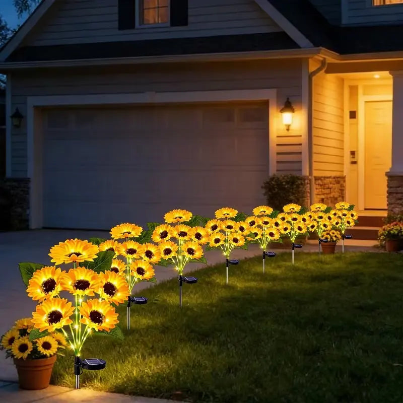 solar-powered sunflower garden lights lining the edge of a front lawn