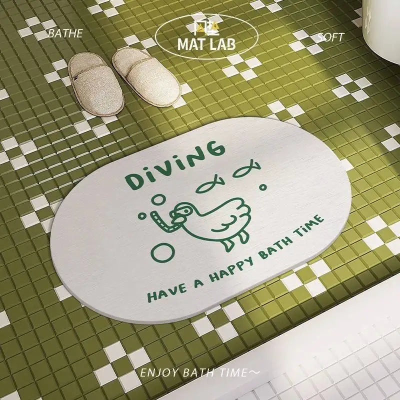 Duck cartoon bath mat on green tile bathroom floor, with slippers nearby