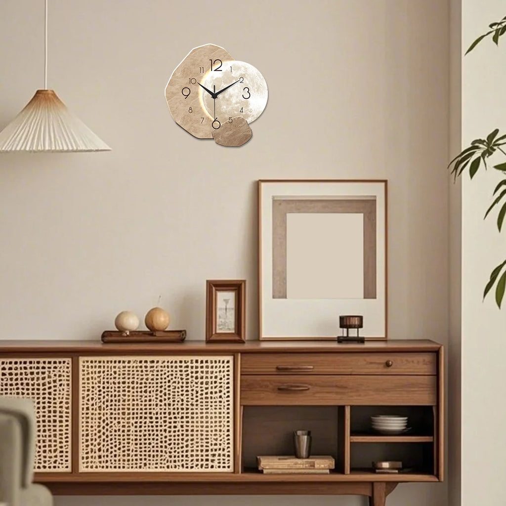 geometric moon wall clock styled above a sideboard in a cozy, neutral room