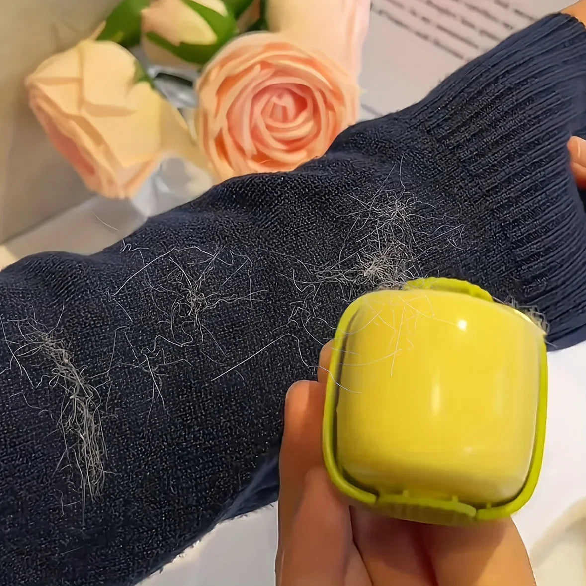 Washing pet hair off a navy blue sweater using the lint roller