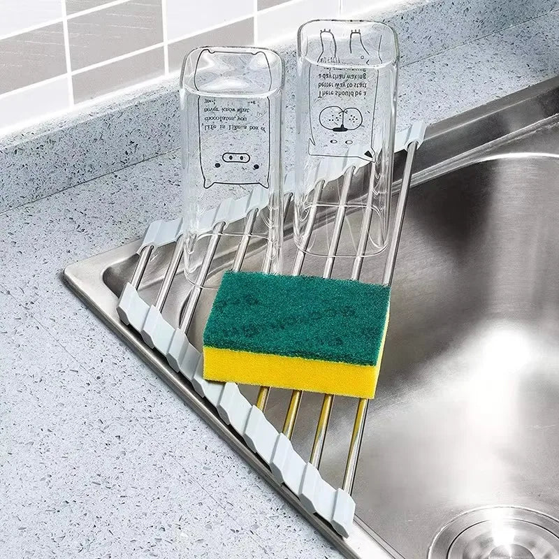 triangular drying rack in kitchen sink holding glasses and a sponge