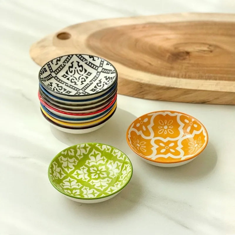 Ten mandala ceramic dishes stacked and displayed in a bright setting