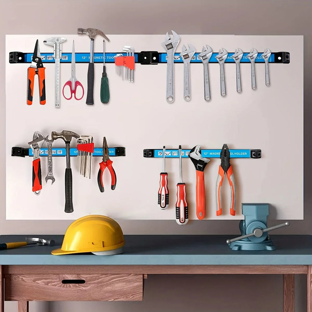 Wall-mounted magnetic tool holders displaying a variety of hand tools in a home workspace above a wooden desk
