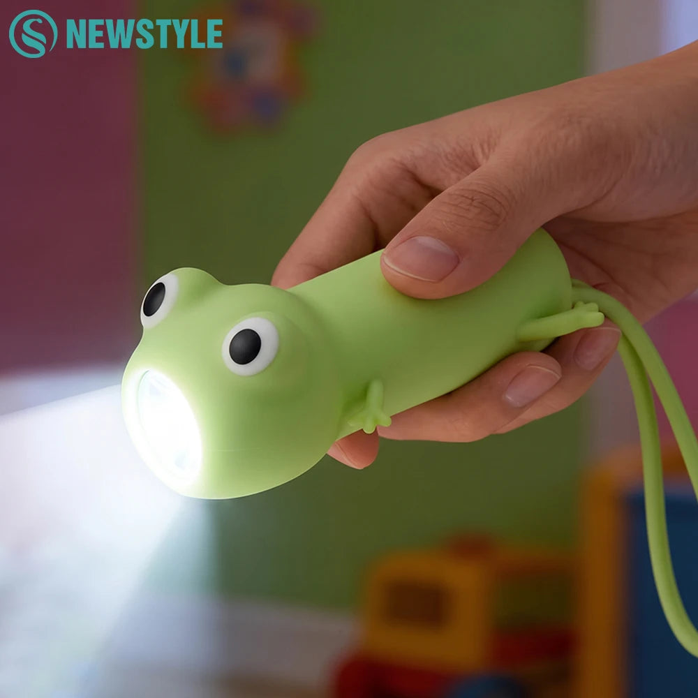 Hand holding frog-shaped silicone kids night light turned on