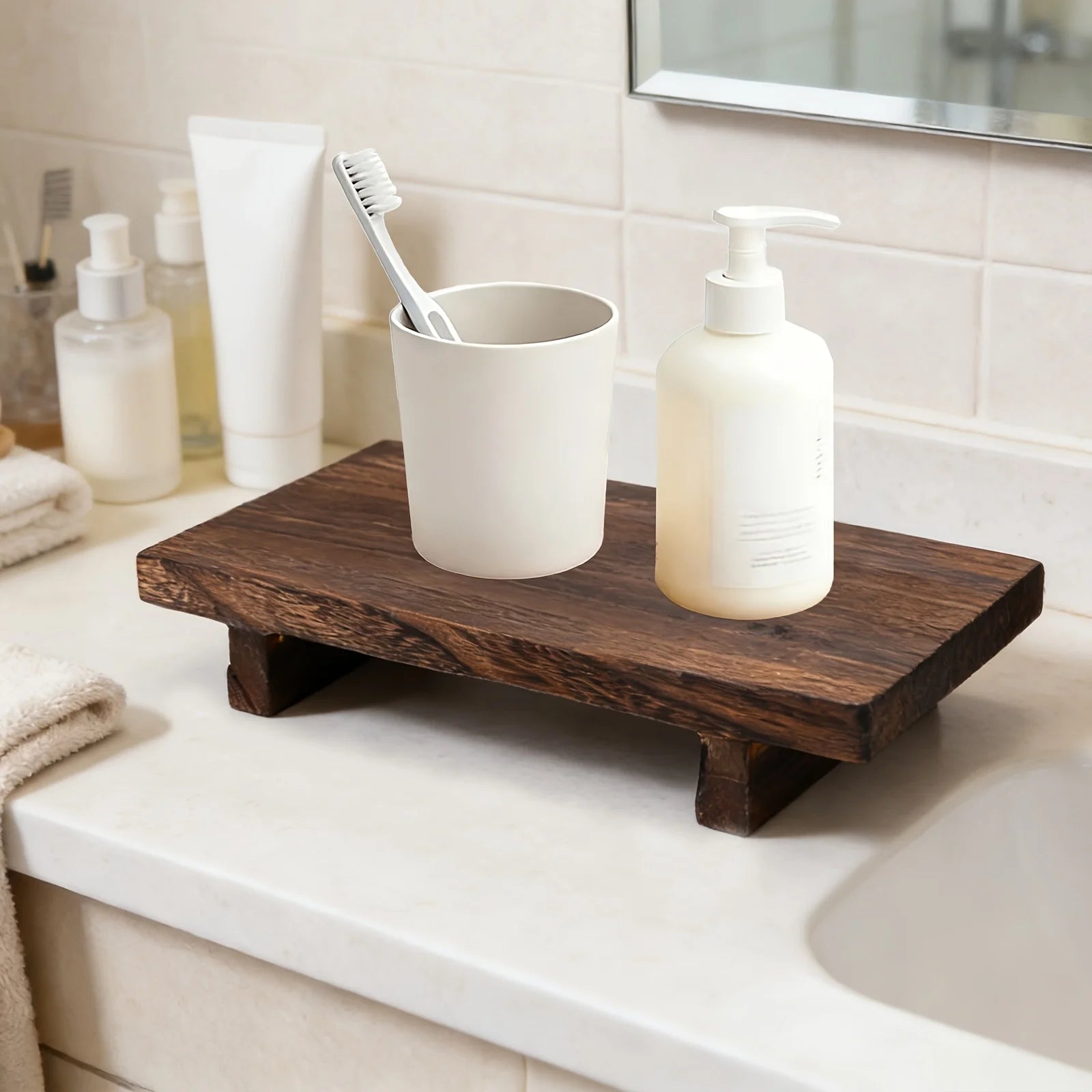 brown wooden tray on bathroom vanity with cup and soap dispenser
