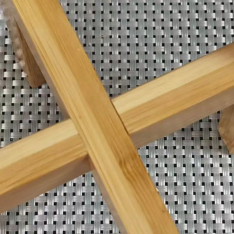 Close-up detail of bamboo plant stand joinery on woven surface