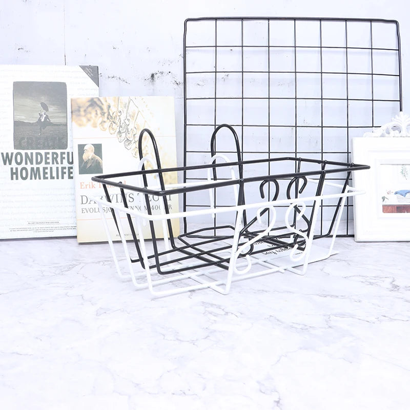 Front angle of black and white hanging wire baskets for railing or grid storage on a marble surface