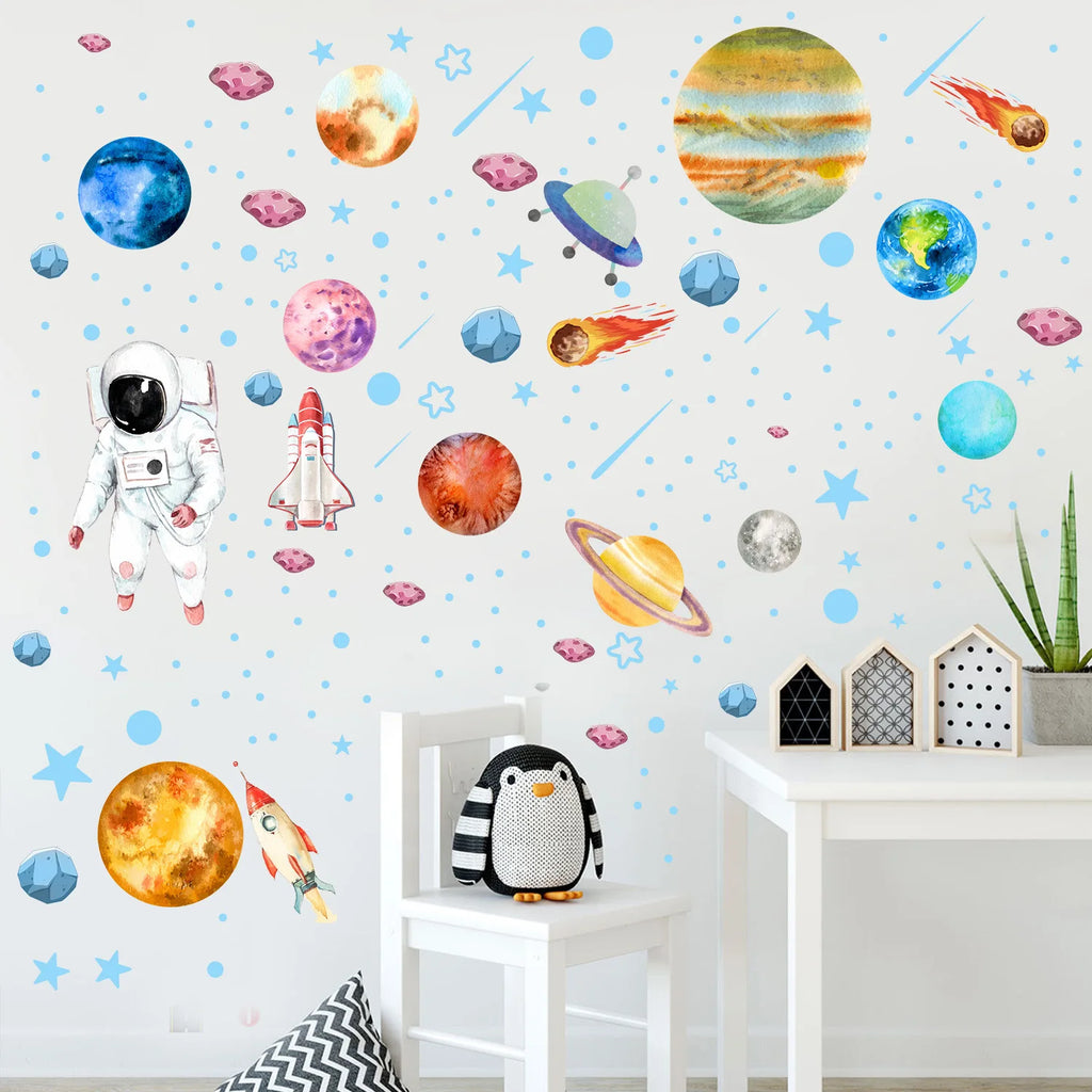 colorful planet and astronaut wall stickers arranged on a white wall in a children's room