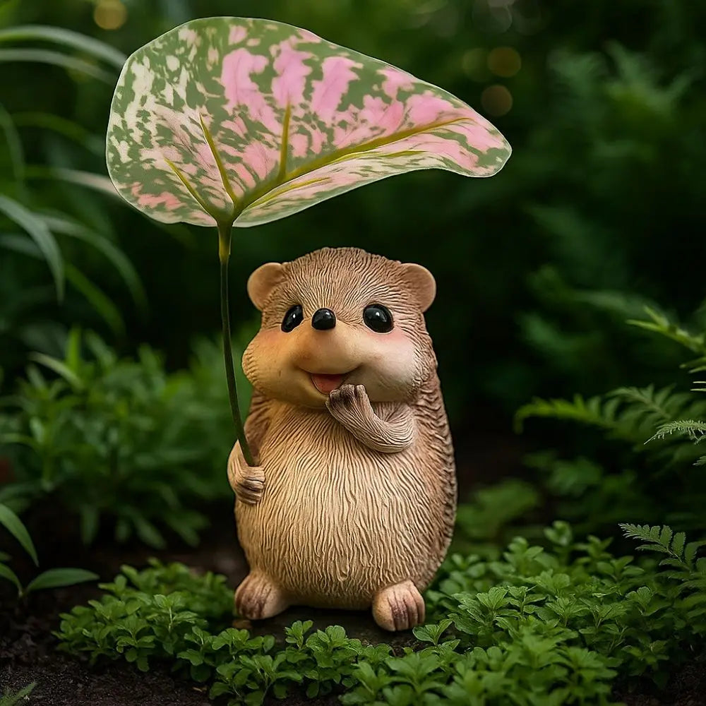 resin hedgehog with pink and green leaf umbrella in lush outdoor foliage