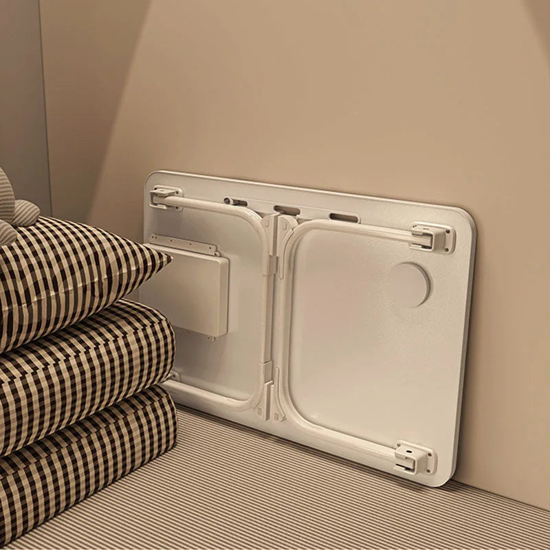 Back view of the foldable bedside desk standing vertically folded beside pillows