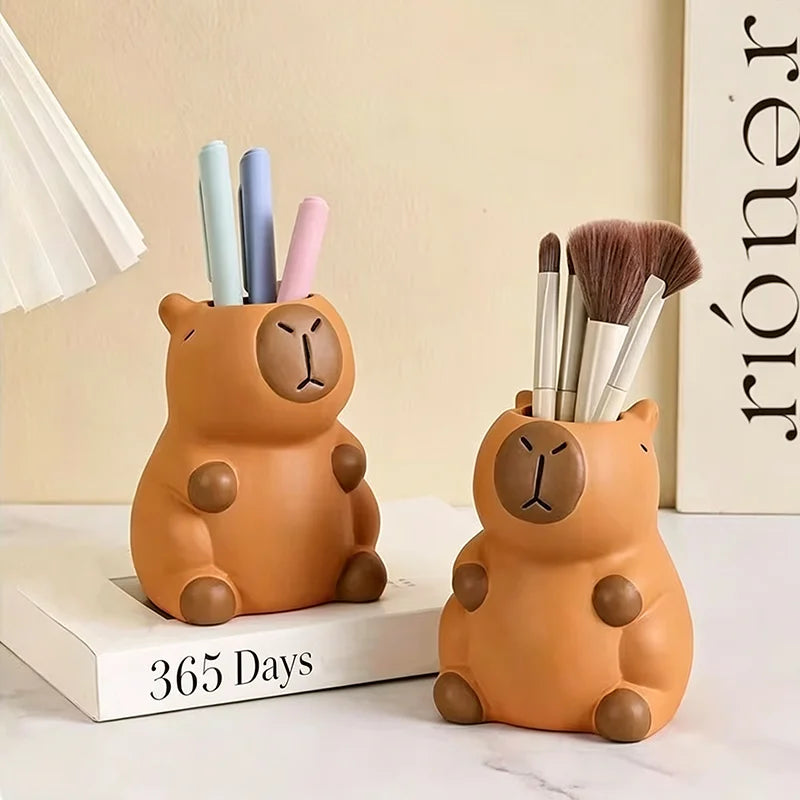 Cute capybara pen holders displayed on a desk, used for pens and makeup brushes