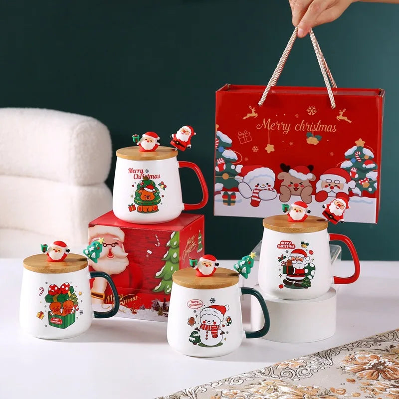 Four ceramic Christmas mugs with festive designs, each with a lid and spoon, packaged in a red holiday gift box