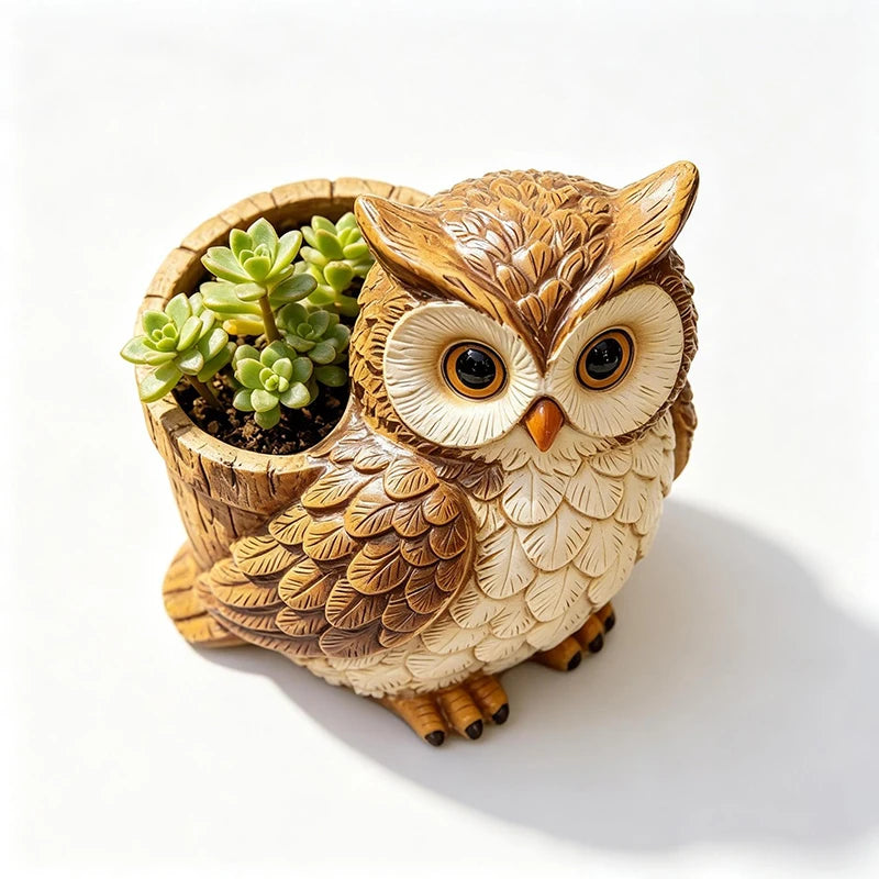 Overhead view of owl resin planter holding succulents, on a plain background