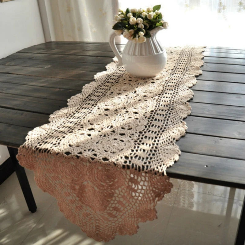 Hand-crocheted cotton table runner with floral lace pattern styled on a wood dining table