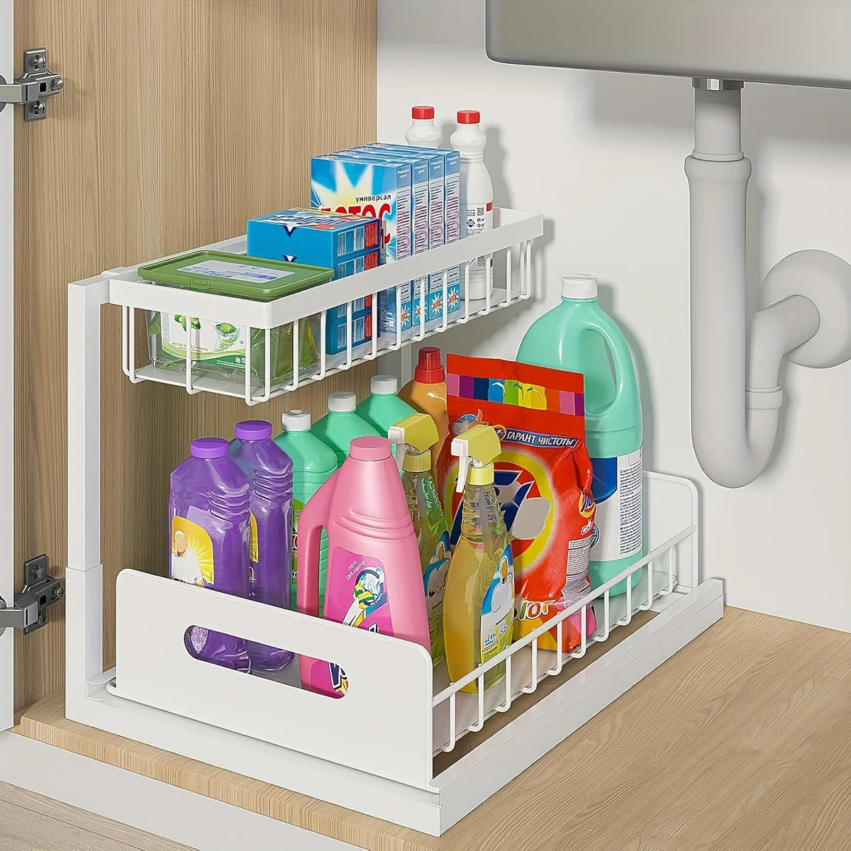 White 2-tier sliding organizer inside a kitchen cabinet storing a variety of cleaning products