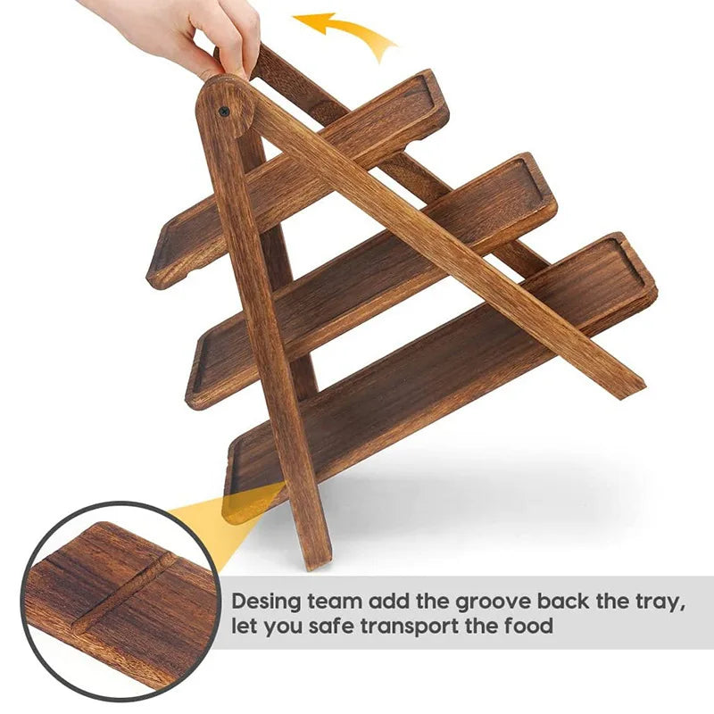 Hand lifting foldable three-tier wooden tray stand showing grooved trays