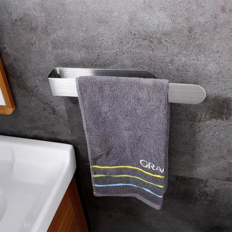 Brushed stainless steel towel bar holding a gray towel next to a bathroom sink