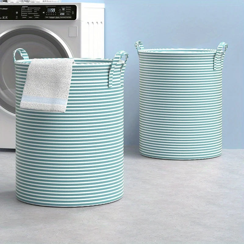 Pair of round striped fabric laundry baskets with handles beside a washing machine