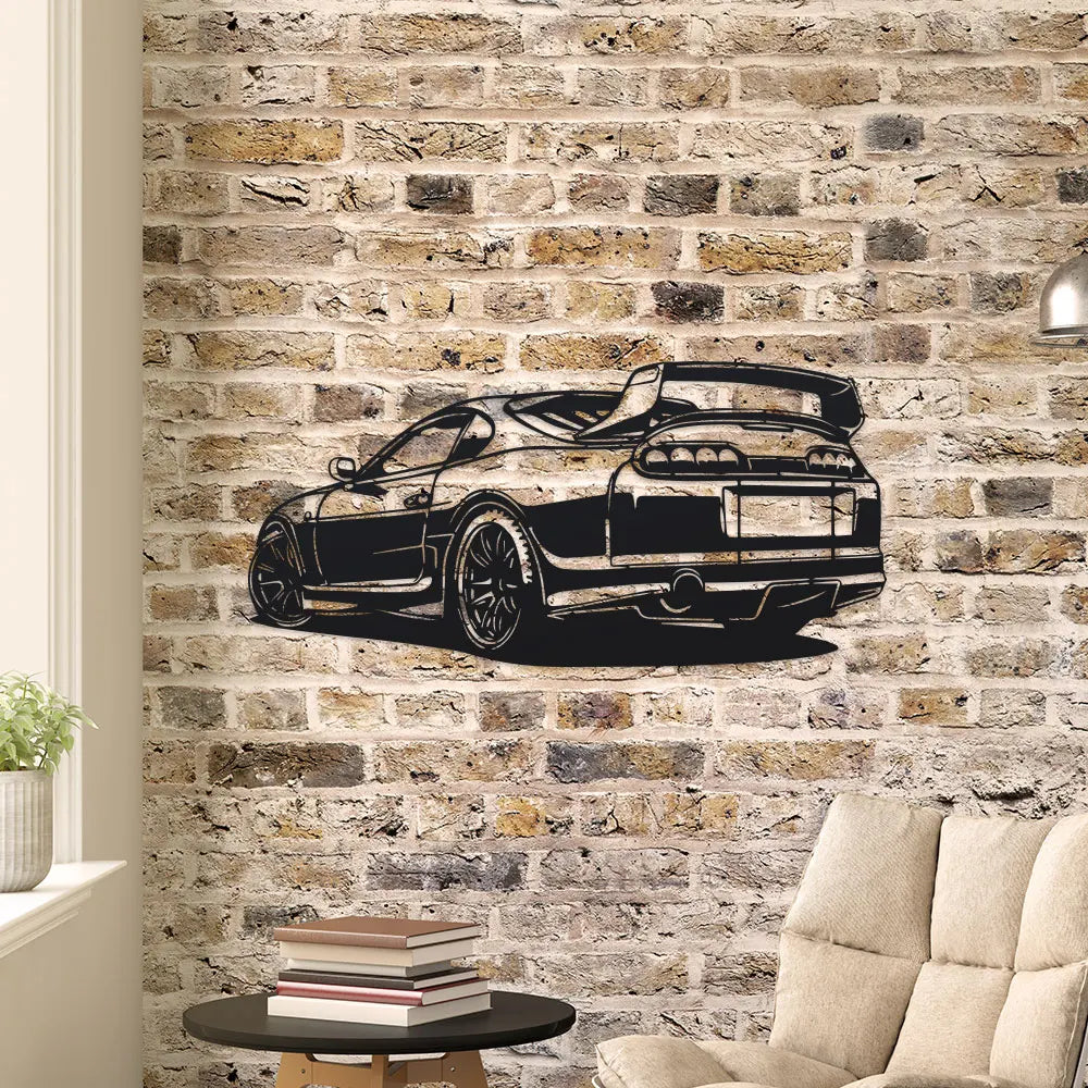 Metal car silhouette wall art mounted on an exposed brick living room wall