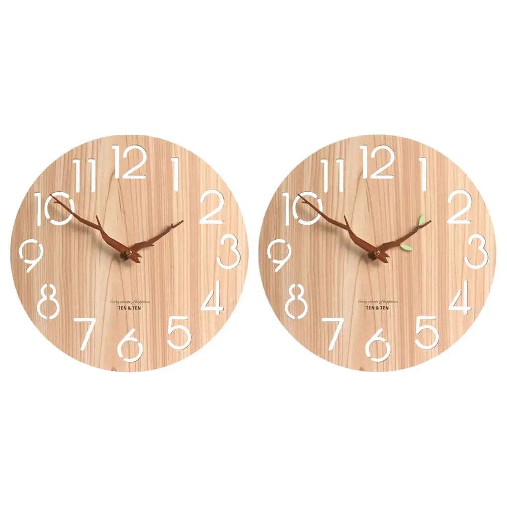 Two round wood wall clocks side by side, one with plain hands and one with a small green leaf accent